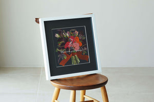Bright orange pressed flower frame on a black background