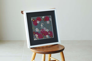 A chic pressed flower frame with red roses reminiscent of the redness of wine