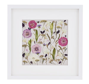 Botanical style pressed flower in white frame.